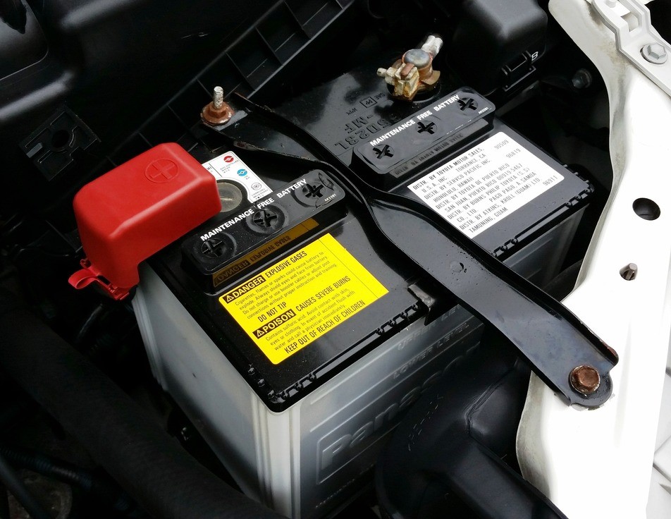new auto battery being installed in car