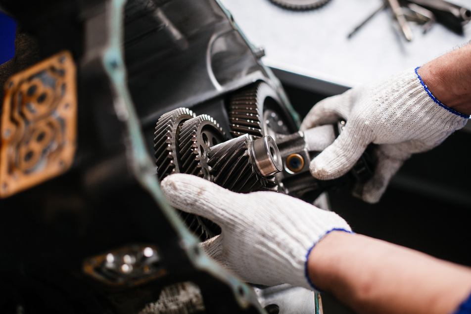 mechanic performing transmission maintenance