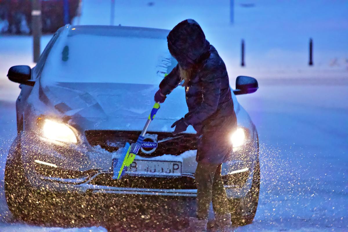 car owner practicing winter car maintenance