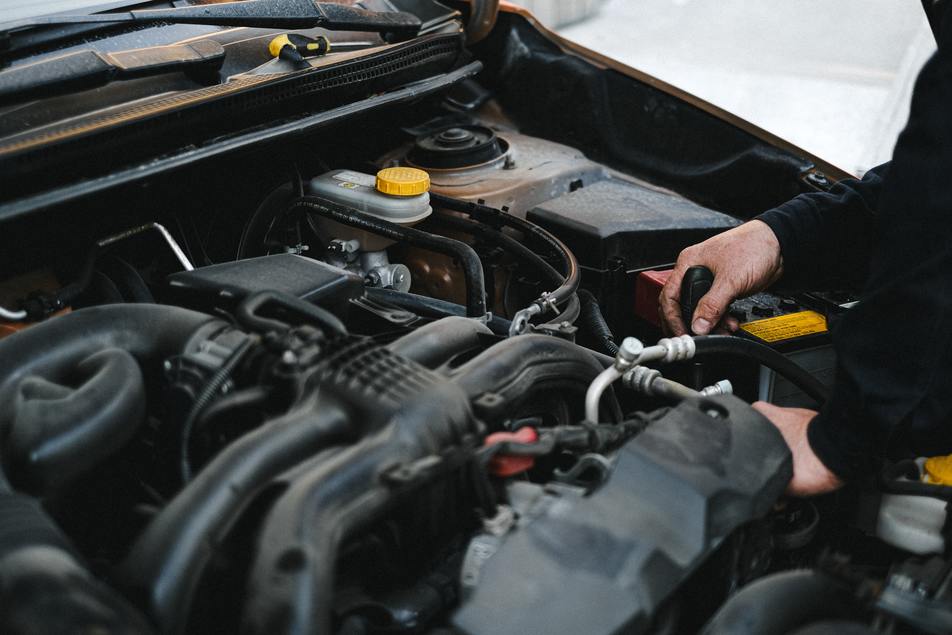 mechanic repairing vehicle engine