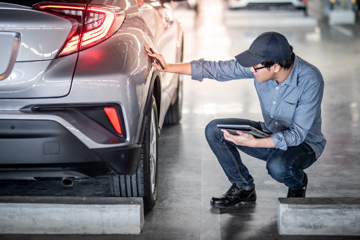 mechanic performing pre-purchase vehicle inspection