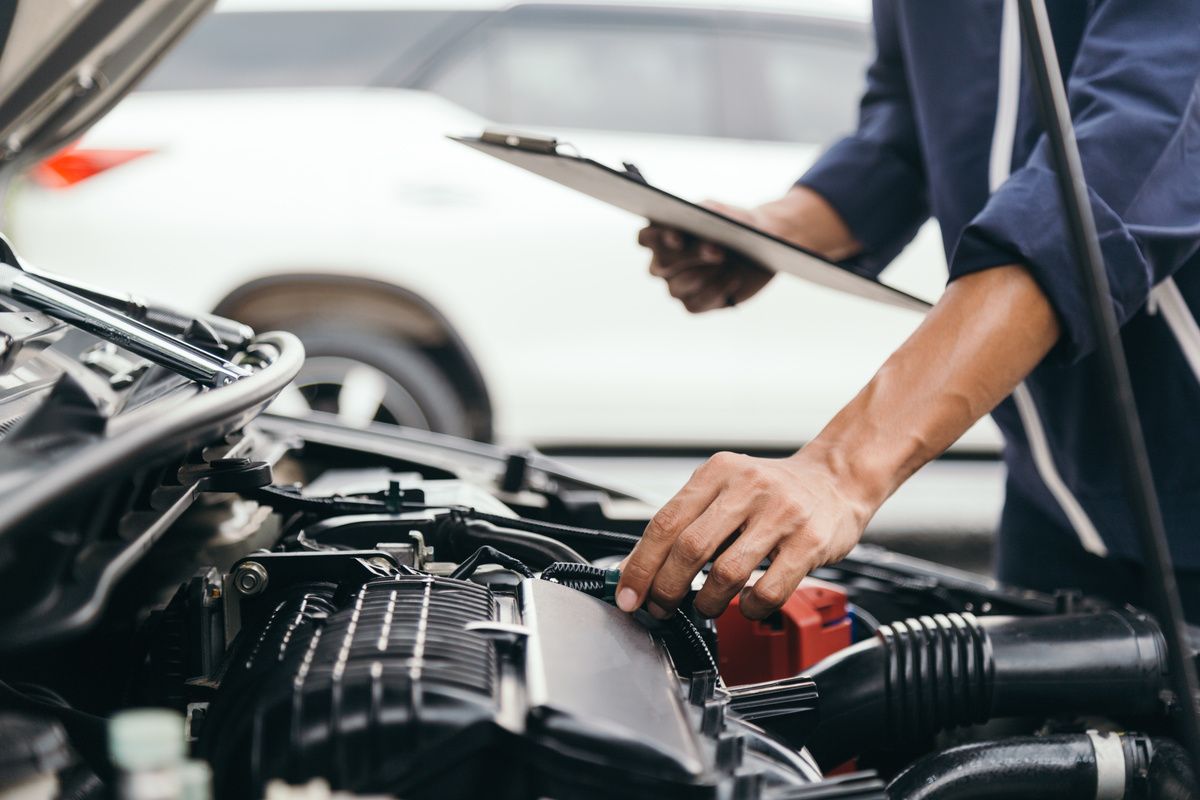 mechanic checking engine vapor canister filter