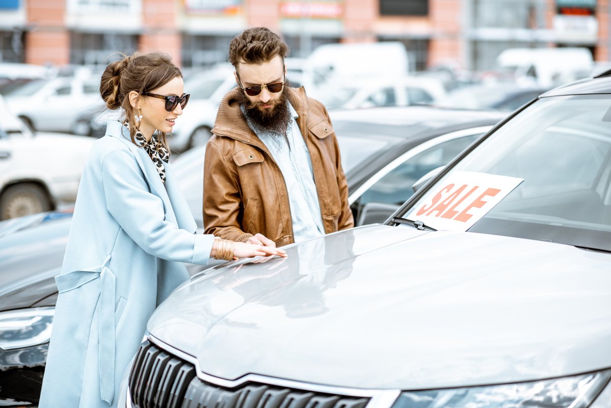 couple looking at used car for sale