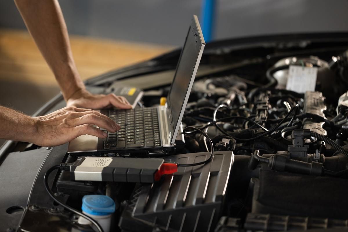 mechanic using auto diagnostics to properly repair vehicle