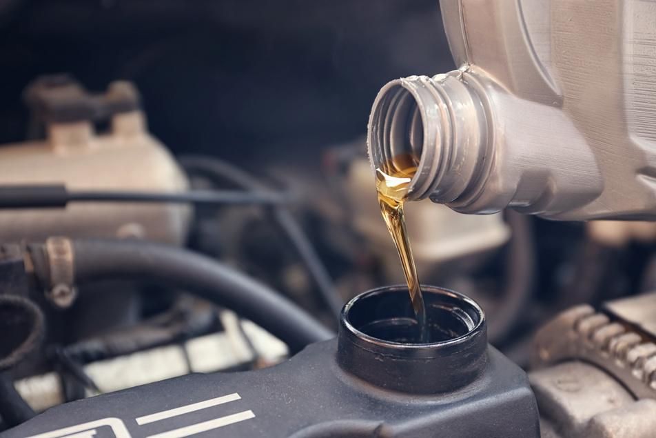 mechanic performing oil change